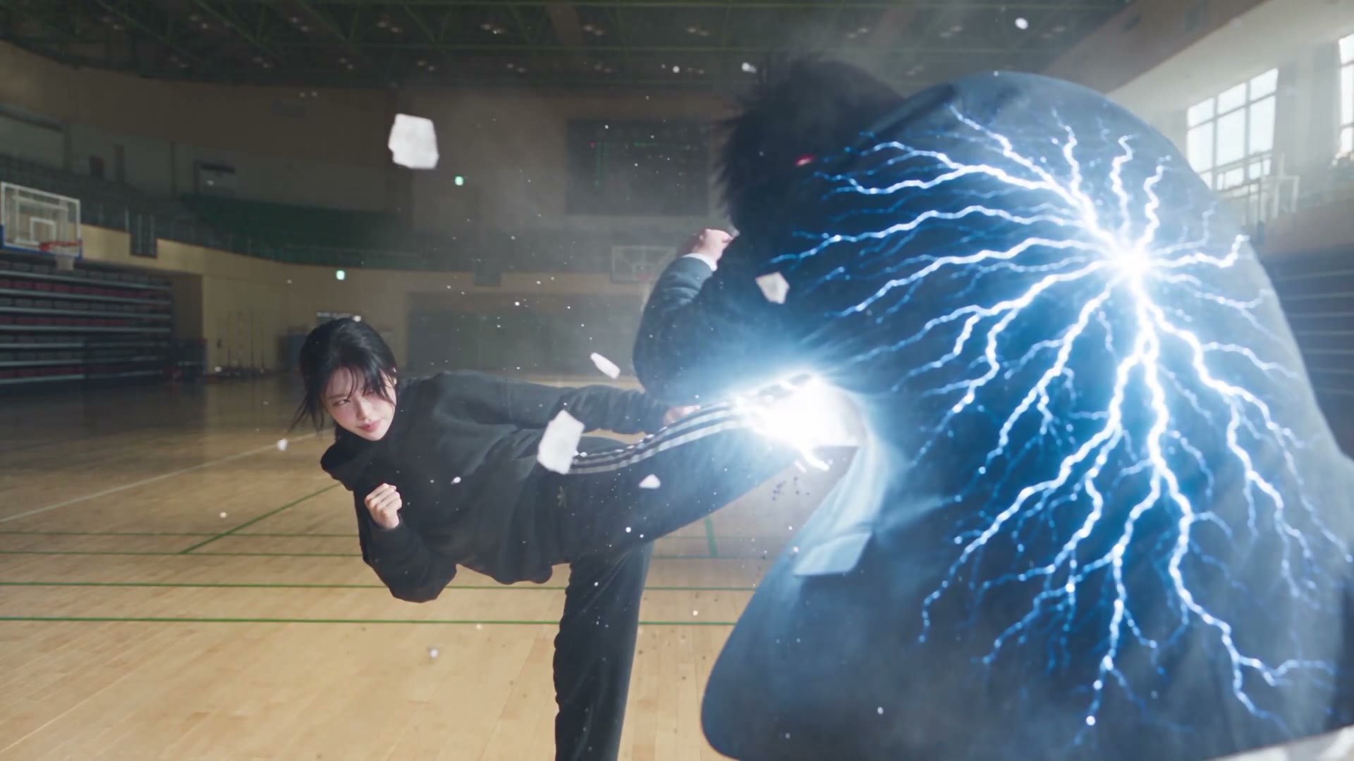 A side kick connecting in an empty Korean high-school gym, branching blue static discharging across the back of the person hit, generated with Seedance 2.5 by WasifAI